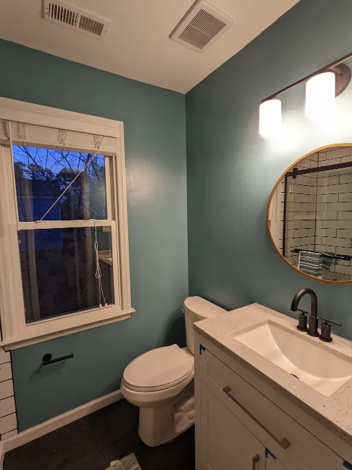 A mirror has been installed above the vanity