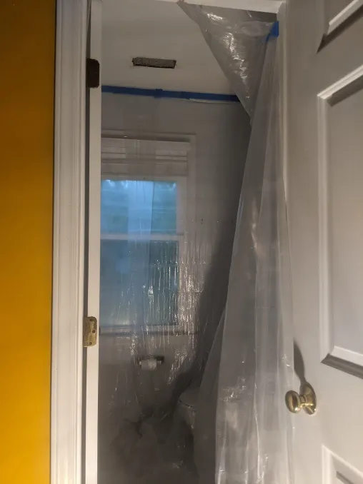 A room wrapped in plastic so that the ceiling can be scraped smooth