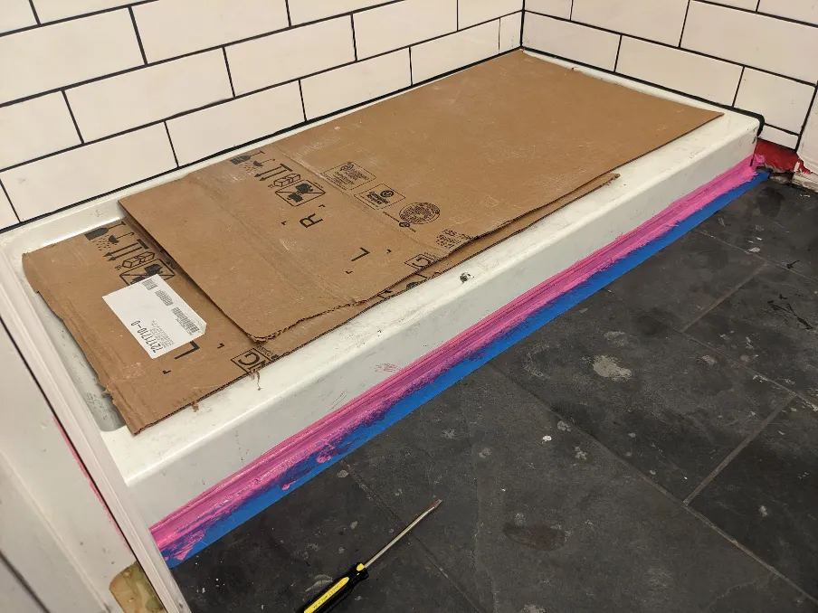 This picture, obviously taken later in the process, shows more red rubber being added around the shower pan