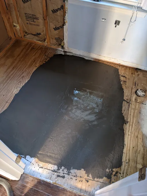 A puddle of cement settles in the middle of the room