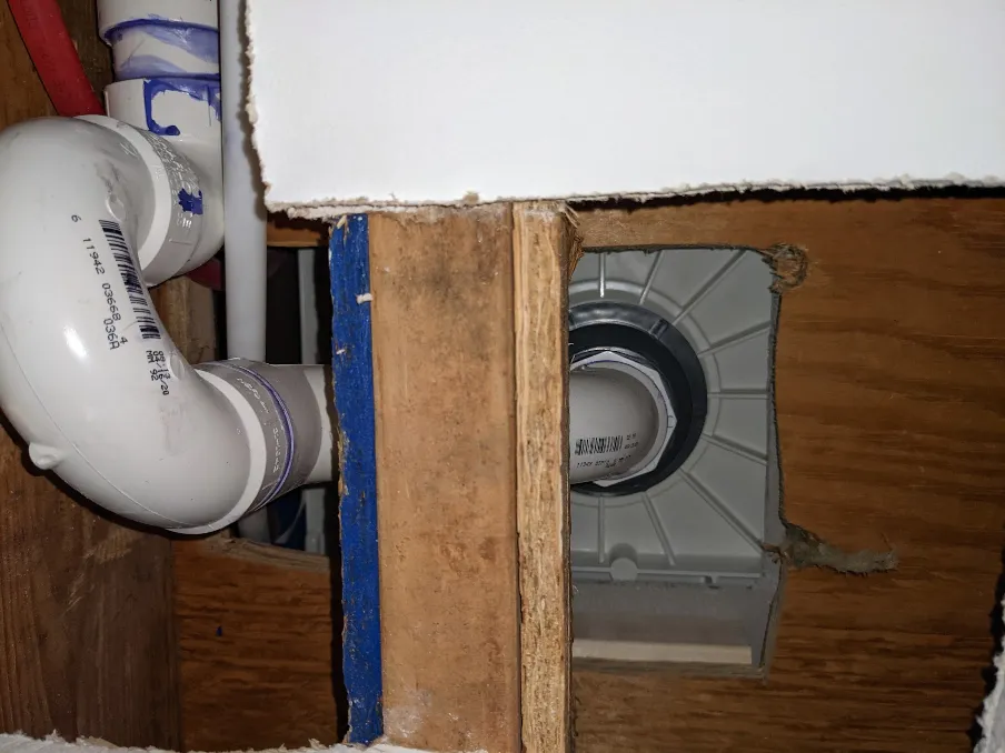 A picture from the floor beneath the bathroom, showing the shower pan from beneath