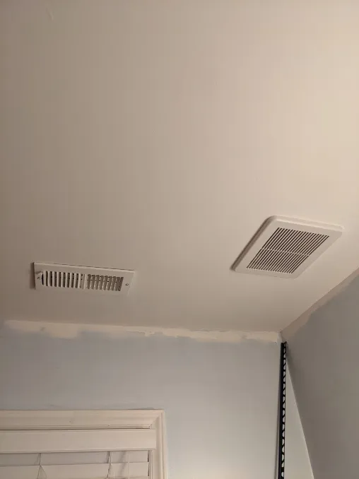 A new fan and vent cover have been installed on the ceiling