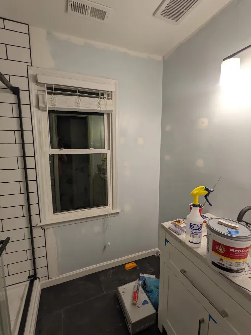 The room is ready for paint, many drywall patches can be seen