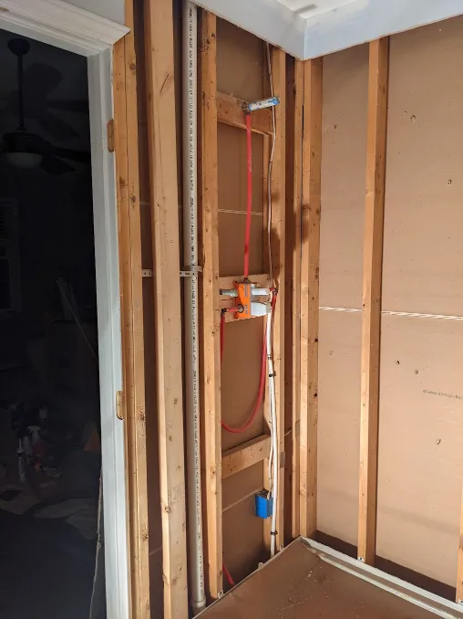 previously hanging pipes have been attached to the part of a shower handle that stays inside a wall