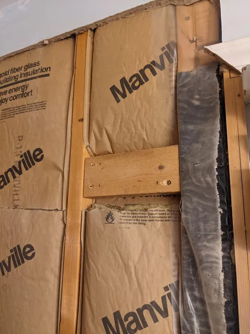 Even more blocking has been added to the wall, a little higher than head height