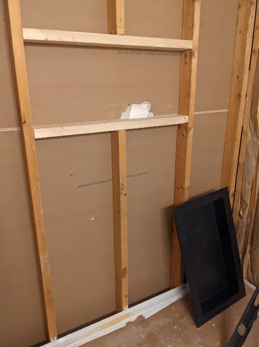 A stud has been cut and two horizontal boards connect the studs on either side of it