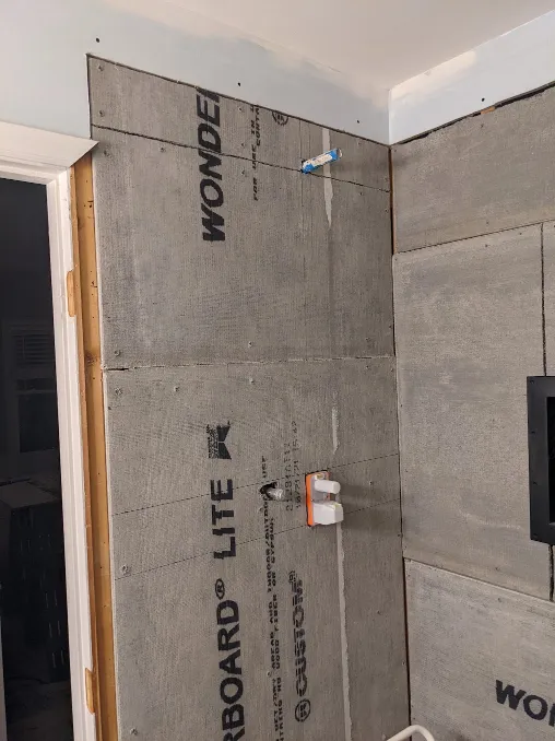 Another angle of the new cement boards, this one showing the shower controls