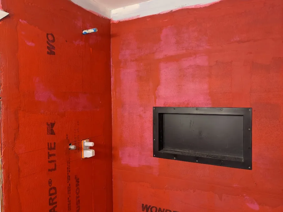 The walls have a bright red rubber coating on them. The plastic niche has been attached.
