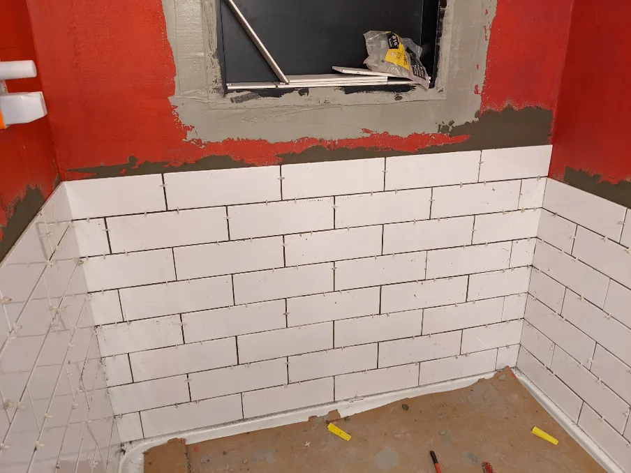 More tiles have been added, covering almost half of the wall