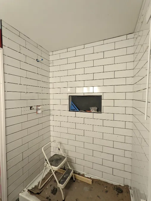 The entire shower is now covered in tiles, from floor to ceiling