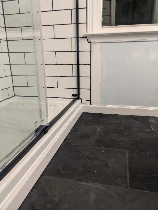 New floor trim has been added around the base of the shower, hiding the platform that it rests upon