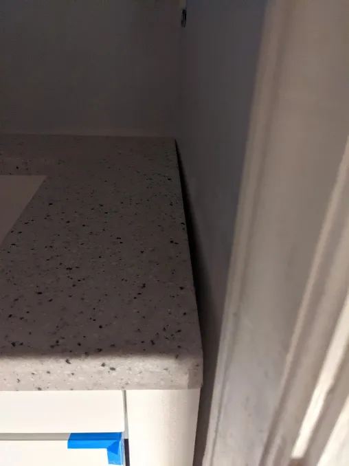 A gap forms between the vanity and the wall beside it. It starts small near the back, but approaches half an inch at the front