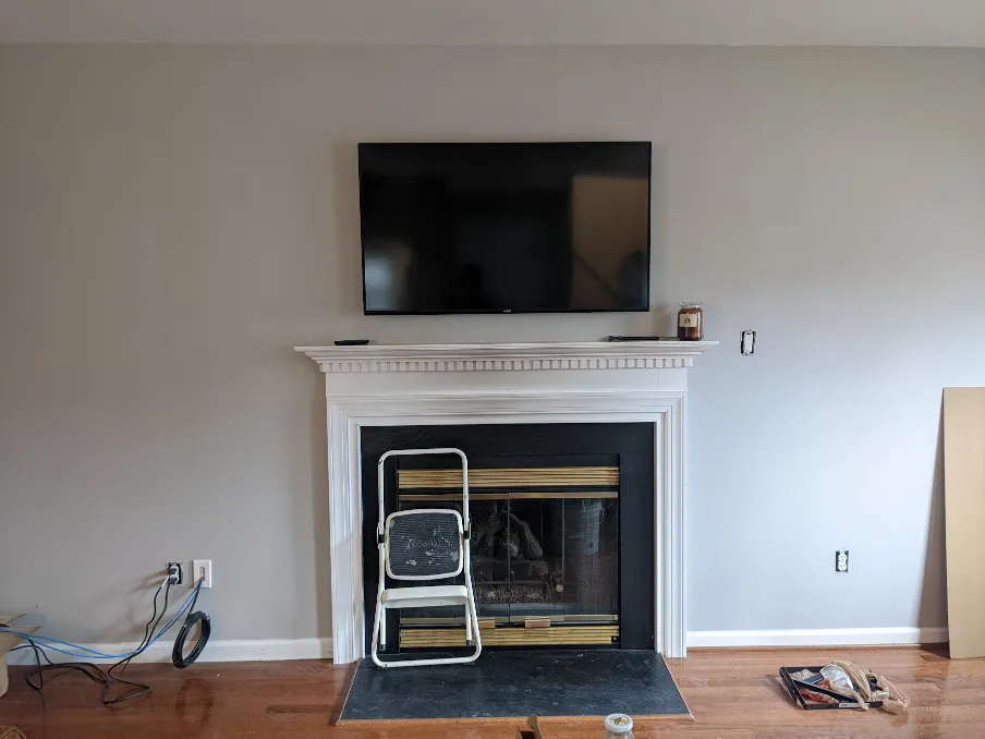 A television hangs from the wall, with no visible wires connected to it