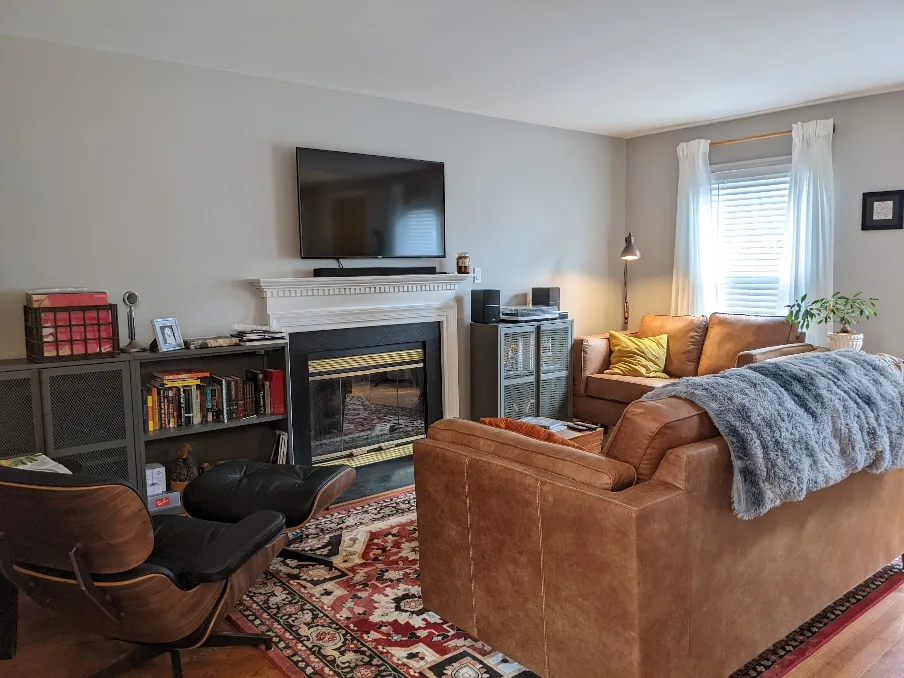 More furniture has been added to the room. The layout is still awkward, but now there is a television