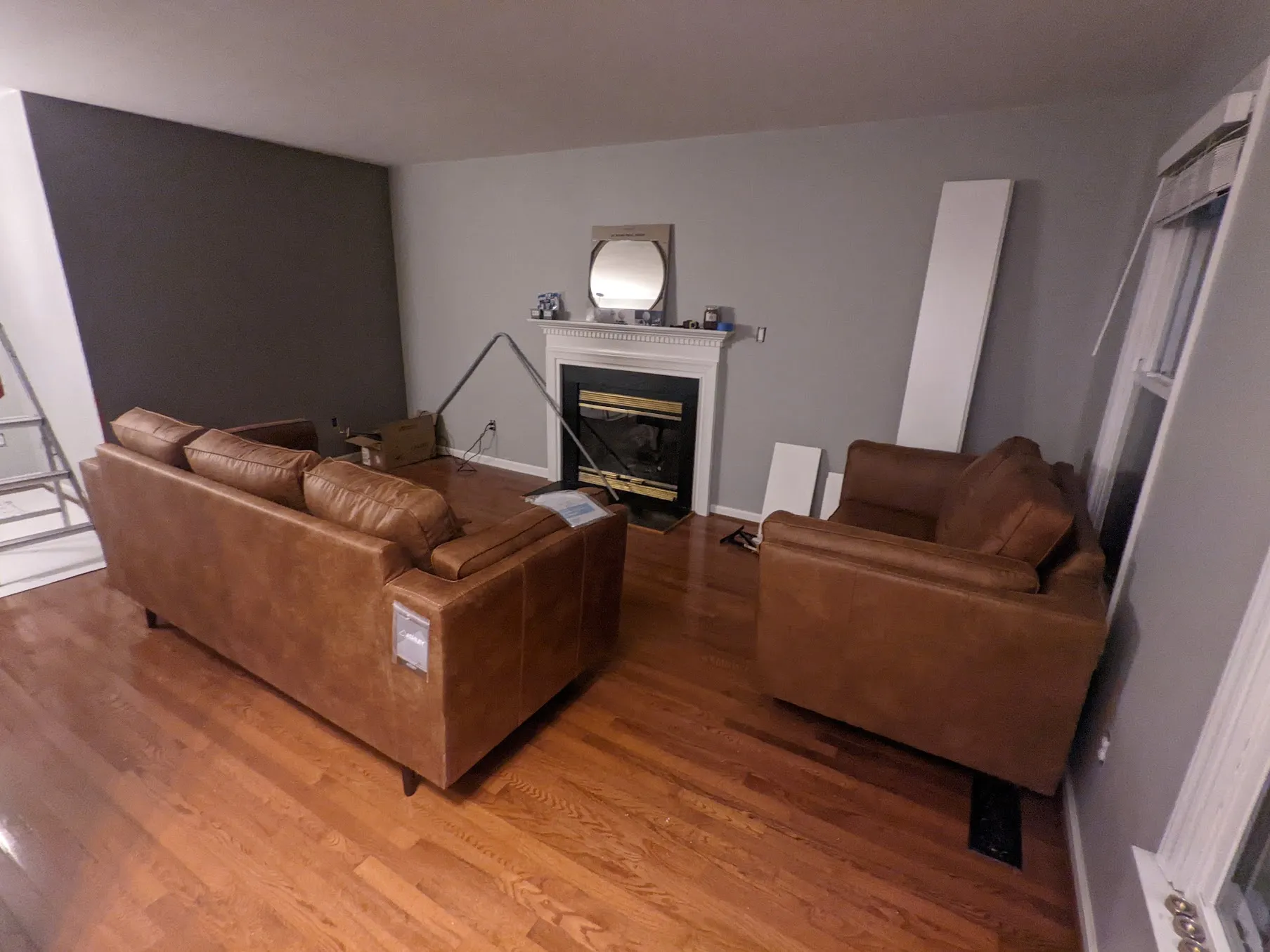 New couches sit in a nearly empty room. The layout is awkward